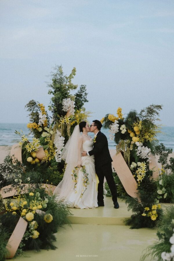 Decor đám cưới ngoài trời bên bờ biển với hoa tươi nghệ thuật, mang đến không gian wedding outdoor lãng mạn và sang trọng.